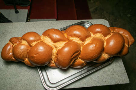 Challah bread with poppy and sesame seeds. Covered with white cover. On white and grey background.の写真素材