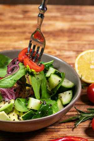 salad mix with avocado and cucumber, with balsamic dressingの写真素材