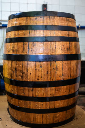 Old wooden barrel on a brown background.の写真素材