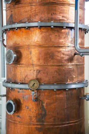 Copper still alembic inside distillery to distill grapes and produce spiritsの写真素材