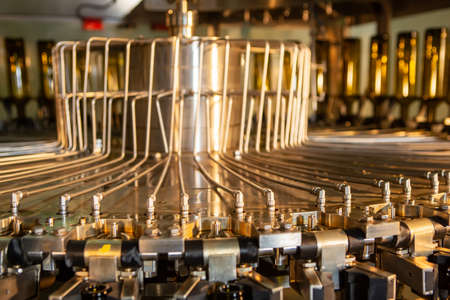 The machine for washing glass bottles. Factory for bottling alcoholic beverages.の写真素材