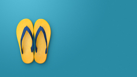 Flip flops isolated on blue background. Top view and copy space. Slippers yellowの写真素材
