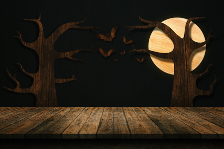Halloween holiday concept. Wooden old table in a shape of wooden bats on the dark wall. For your product placement or montage with focus to the table top in the foreground. shelvesの写真素材