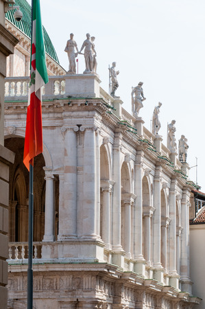 One of the side of the Basilica palladiana in Vicenza with the town flag on the leftの写真素材