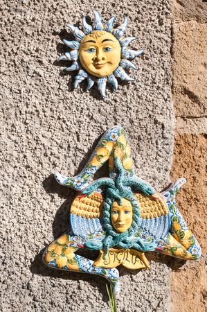 Some typical ceramic souvenirs from Caltagirone hung outside a tourist shopの写真素材