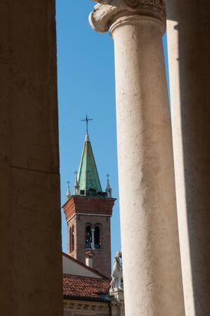 The bell tower of St. Vincenzo church in Vicenza seen from a loggia of the basilica palladianaの写真素材