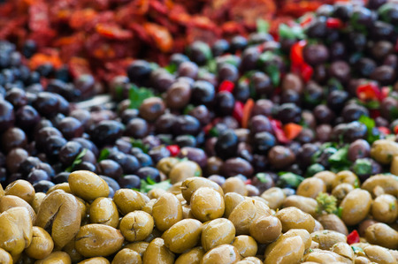 View of green and black olives in a sicilian weekly marketの写真素材