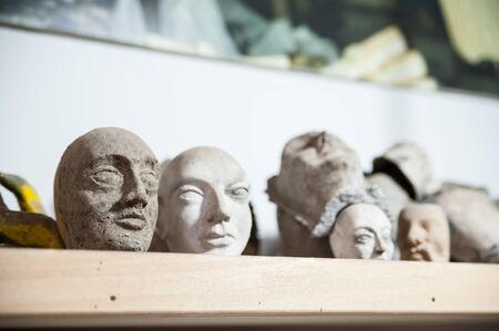 View of some papier-mâché heads of unfinished Sicilian marionettes in the studio of a puppet artisan in Syracuseの写真素材