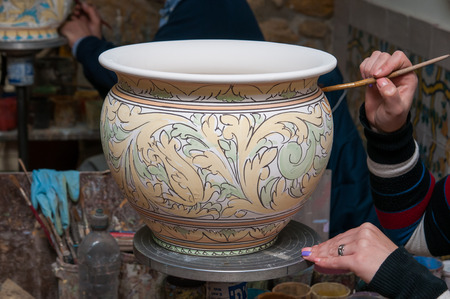 View of a ceramic pot from Caltagirone being decorated by a local artisanの写真素材