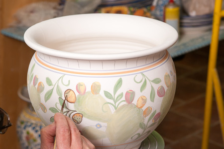 View of a ceramic pot from Caltagirone being decorated by a local artisanの写真素材