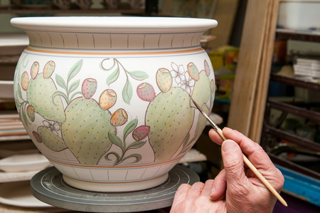 View of a ceramic pot from Caltagirone being decorated by a local artisanの写真素材