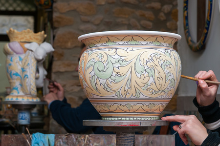 View of a ceramic pot from Caltagirone being decorated by a local artisanの写真素材
