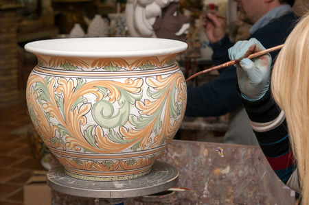 View of a ceramic pot from Caltagirone being decorated by a local artisanの写真素材