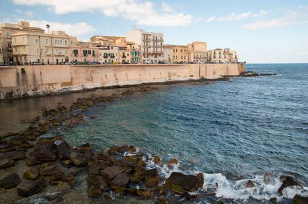Eastern side of the ancient part of Syracuse Ortigia Sicily with sea and rocksの写真素材