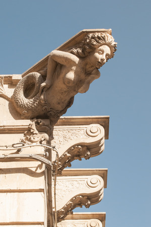 Ornamental sculpture of a mermaid on the roof of a Baroque palace in Lentini, Sicilyのeditorial素材