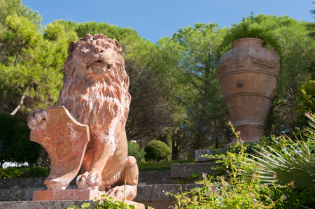 Ornamental ceramic statue of a lion in the public gardens of the town Caltagironeの写真素材
