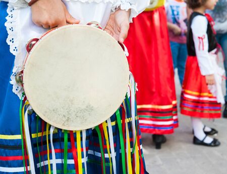 Folkloristic sicilian tambourine held by a a girl with a typical regional dressの写真素材
