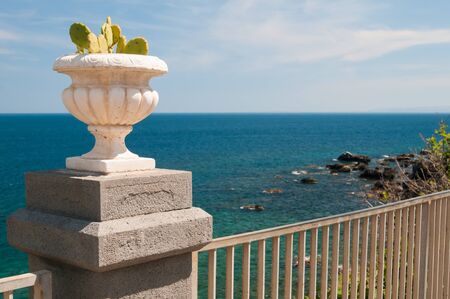 Ornamental cactus vase along the seafront of Acicastello, a village in the province of Catania, Sicilyの写真素材