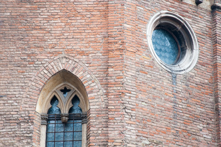 Pointed arch and rose window in the external sides of the gothic Cathedral in Vicenza, Italyの写真素材