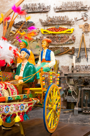 Model of a sicilian cart inside the workshop of folkloric craftsmanship Rosso Cinabro in Ragusa Ibla, Sicilyの写真素材