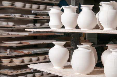 Just enamelled vases ready to be painted in the workshop of a pottery artisan in Caltagironeの写真素材