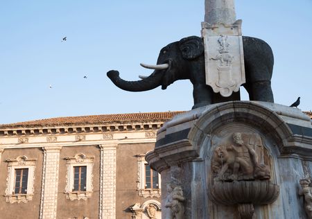 The famous lava stone statue of an elephant and its obelisk in the main Square of Catania, Sicilyの写真素材