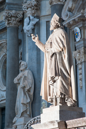 Night view of an external statue in the facade of Saint Agatha Church in Catania, Sicilyの写真素材