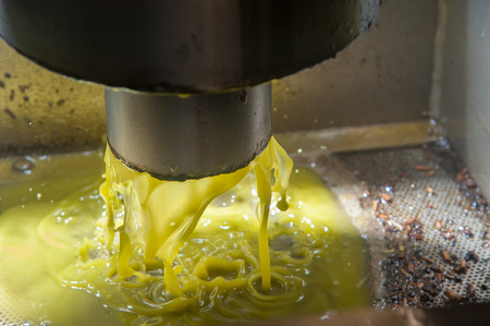 Waste water of the olives pressing process falling onto a basinの写真素材