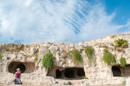 Section of the upper part of the greek theater in Syracuse with its typical rock cut tombsの写真素材