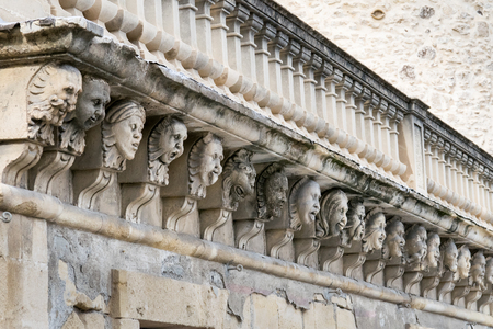 Closeup view of mascarons with  funny faces under the balcony of a baroque palace in the province of Syracuse, Sicilyのeditorial素材