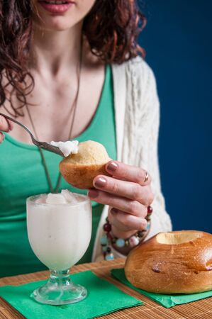 Girl eating a typical sicilian almond granita with a warm briocheの写真素材