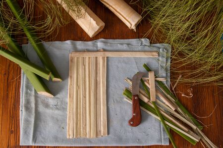 Strips obtained from the stem of papyrus plant with a typical knife and a finished rolled up sheets