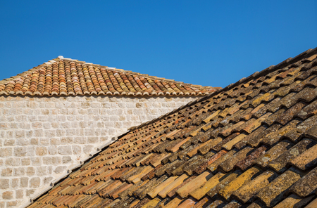 Traditional Mediterranean houses with red tiled roofs and Dubrovnik fortress bastions,Dalmatia,Croatia,Europeの写真素材