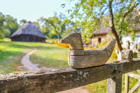 Ancient traditional Ukrainian figure of a bird on the fenceの写真素材