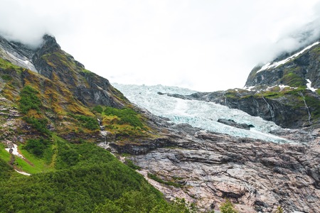 Melting Briksdal glacier in Norway, close up. Panorama from bottom to top. Norway nature and travel...