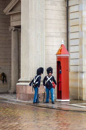 Copenhagen, Denmark - June, 2018: Royal Guard at Amalienborg. The palace and residence in Copenhagen of the queen of Denmark. Royal Guardsman guard change near Amalienborg Palace, Copenhagen.のeditorial素材