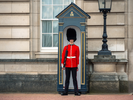 London, UK - April, 2019: English guard patrolling in London. Solider of Buckingham palace, London England.のeditorial素材