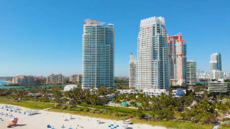Aerial stock Miami Beach Spring break vacation. Beautiful sunny day at South Beach, Florida. Aerial over hotels, condos and beach goers on South Beach. Aerial video stock footage, Miami, Florida.の写真素材