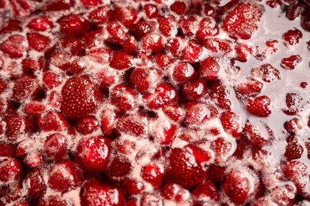 Strawberry jam, top view. Homemade Strawberry jam in making progress boiling. Boiling strawberry jam close up. Strawberry jam is boiling, detailed shooting.の写真素材