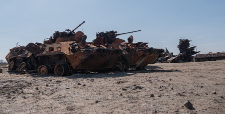 Bucha, Ukraine - April 2022: Burnt and destroyed military equipment by Russian invaders. Russian armored personnel carriers at the cemetery of Russian equipment in Ukraine. War 2022 Ukraine vs Russia.のeditorial素材