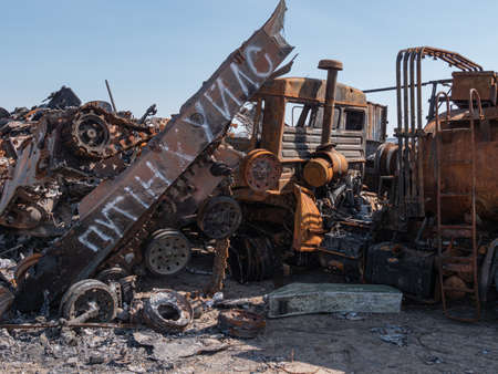 Bucha, Ukraine - April 2022: Inscription - Putin is fucker, on a destroyed Russian tank. Russian...