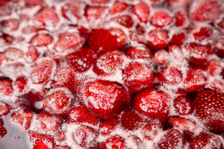 CLOSE UP: Strawberry jam. Make a strawberry jam. Boil strawberries in the pan. Process of cooking, boiling berries for canning. Healthy sweet food. Cooking strawberry jam close up.の写真素材