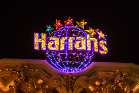 Las Vegas, Nevada - March 2017: Sign of the hotel Harrahs glows and flashes at night on the roof of the building. Bright signs of Las Vegas at night. Casino Harrahs flashes bright lights.のeditorial素材