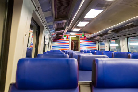 Interior of a high-speed train moving at high speed during the day in cloudy weather. Window view from fast train travelling in the Netherlands. Car of the train view from inside. Train travelingの写真素材