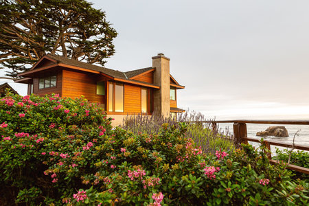 Eldwayen Ocean Park, Pismo Beach, California- April 2017: Small coastal house on the very shore of the ocean in the rays of sunset. House with beautiful ocean view. Sunset on Pismo Beach in Californiaのeditorial素材