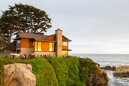 Eldwayen Ocean Park, Pismo Beach, California- April 2017: Small coastal house on the very shore of the ocean in the rays of sunset. House with beautiful ocean view. Sunset on Pismo Beach in Californiaのeditorial素材