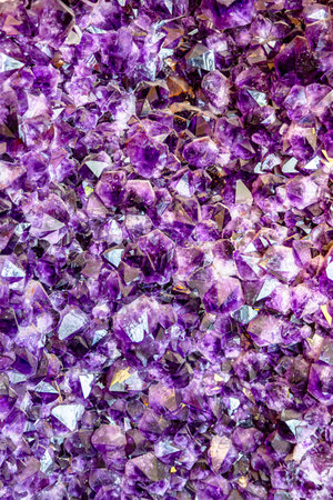 Gemstones amethyst bright purple, texture of stone. Beautiful background of amethyst stones. Close up purple shining amethyst quartz crystal texture abstract backgroundの写真素材