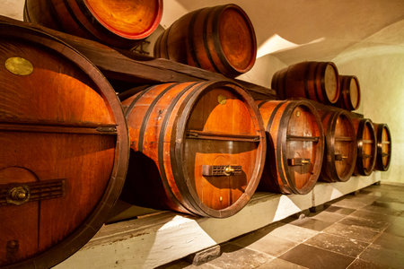 Wine barrels stacked in the old cellar of the winery. Traditional winemaking.の写真素材