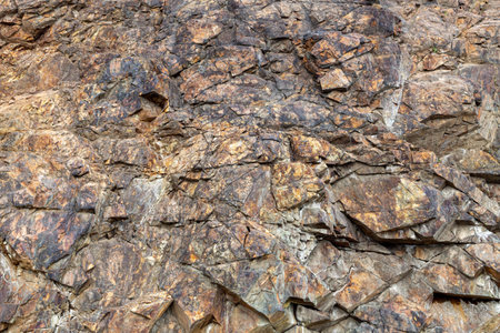 Rock, background, texture, patterns on rock stones. Orange stone texture. Red brown stone background. Rock surface. Mountain texture. Close-up. Natural rock surface, backgroundの写真素材