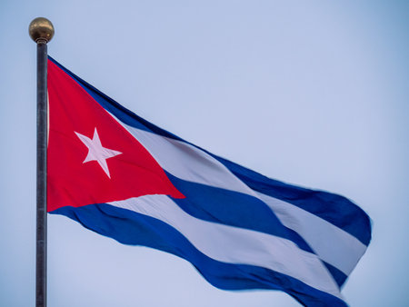 Cuba Flag Waving on flagpole, close up. Cuba flag flapping in the wind. Close-up of an Cuban flag flying in the wind against a background of clear sky. Cuba flag full frameの写真素材